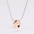 Macro shot of rose gold snake chain and irregular concave pebble pendant with mirror finish - Rose Gold