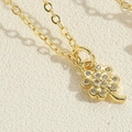 Close-up of golden clover pendant featuring intricate cubic zirconia pavé setting detail - Pave Zirconia Clover