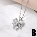 Pendentif nœud argenté élégant avec zircone sur marbre blanc et tissu en soie - Nœud 3D à la Mode (B)