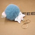 Detail of light blue faux fur fox keychain with pink PU leather head and gold clasp - Teal