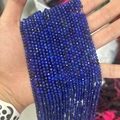 Faceted deep blue lapis lazuli beads for DIY jewelry making held in hand for scale - Premium Lapis Lazuli 3mm