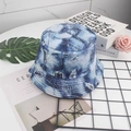 Detail of double-sided denim print bucket hat with retro distressed graffiti patterns - Denim Ripped