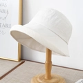Minimalist beige cotton linen sun bucket hat for women on a wooden display stand - Minimalist Textured Style / 12136 Beige