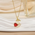 Elegant cherry pendant necklace with red and white heart-shaped stones on gold chain - Bicolor Heart Gem Cherry Style (XL0584)
