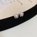 Macro detail of silver hollow flower stud earrings with elegant matte texture - Silver