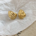 Close-up of gold shell texture earrings on minimalist white and beige fabric background - Shell Wave Style (HE27803) / Gold