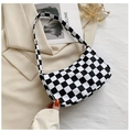 Detailed close-up of a black and white checkerboard shoulder bag with gold metal zipper - 23*13*7 / Black and White Plaid