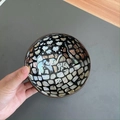 Detailed view of handmade coconut bowl with inlaid shell elephant pattern and brown exterior - Black Base Mother-Child Elephant