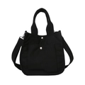 Minimalist black canvas tote bag with adjustable shoulder strap and silver snap buttons - Black