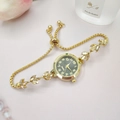 Detail of gold leaf watch bracelet with black dial and crystal accents in elegant setting - Gold Color Black