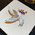 Macro detail of peace dove brooch with white enamel wings and sparkling rhinestones - Brooch - Gold - White