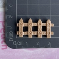 Detailed close-up of a miniature beige resin fence accessory measured on a cutting mat - Coffee Fence / Shiny Coffee