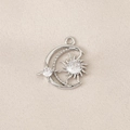 Macro view of a silver moon and sun pendant with zircon crystals on silk fabric - PJ0119-Silver (Star & Moon)