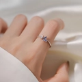 Silver butterfly ring with blue enamel and sparkling cubic zirconia on white satin - J5054 Silver Blue Enamel Butterfly Ring