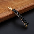Detail view of gold metal hair clip featuring polished natural black crystal stones - Obsidian Gold