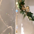 Rainbow crystal suncatcher with gold metal rings and teardrop pendant on branch - B16 Style