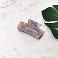 Macro view of a colorful marble-patterned acetate hair claw clip on marble background - Purple Floral (Medium)