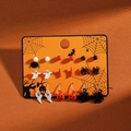 Close-up of a 9-pair Halloween earring set featuring ghosts, pumpkins, and bats on a card - DE8803