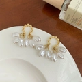 Elegant gold bead and white pearl drop earrings displayed on a white ceramic plate - Gold Beaded Cluster Teardrop Pearl