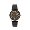 Close-up of black matte watch dial with large rose gold numerals and leather strap - Black