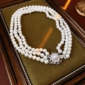 Macro shot of multilayer pearl necklace with silver flower clasp on green velvet - Three-row Necklace Style / Necklace-White-Glass Pearl 8mm