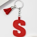 Close-up of red PU leather letter S keychain with decorative tassel and metal ring - Red-Letter S