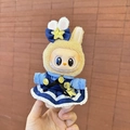 Labubu plush doll in yellow bunny outfit and blue dress with star decorations - Star Rabbit Officer Pendant / First And Second Generation Keychains Are Compatible With La Cloth Dolls. Dolls Not Included.