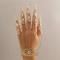 Detail of gold gothic finger armor bracelet with claw rings and intricate hollow patterns - Claw Fingernail Hand Harness / Gold (2264)