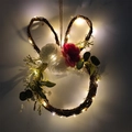 Bunny-shaped rattan Easter wreath with flowers and warm white LED lights on a white wall - Style 1 (With LED)
