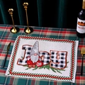 Detailed view of woven Christmas gnome placemat with JOY text on festive holiday table - Style B