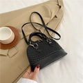 Mini black shell crossbody bag with quilted texture and golden hardware details - Black