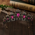 Detail of baroque alloy crown with pink teardrop gemstones and black crystals on wood - Antique Gold + Rose Red Rhinestone