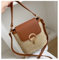 Straw woven crossbody bag with brown leather trim and golden circular metal buckle - Brown