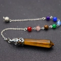 Detail of tiger eye hexagonal stone pendant with silver carved cap and seven chakra beads - Tiger's Eye