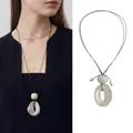 Detail of wax rope necklace with matte beige bead and irregular metal ring pendant - Minimalist Bead Glossy Metal Ring Style (20#)