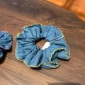 Blue denim scrunchie with yellow wavy scalloped edges on a rustic wood background - Blue Denim Scrunchie with Yellow Trim