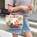 Beige canvas handbag with pink handles featuring colorful cartoon monsters and FUNNY text - Cute Monster Carnival