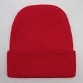 Detailed close-up of solid red knitted beanie showing premium textured wool yarn fabric - One Size / Red