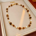 Detail of vintage necklace with tiger eye stones, pearls and golden beads in a gift box - Necklace-Brown-White