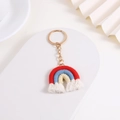 Handmade red and blue knitted rainbow keychain with white tassels and golden ring - Red