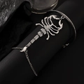 Close-up of silver scorpion finger bracelet with white rhinestones on dark leather - Crystal Scorpion Style (1770)