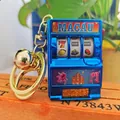 Blue mini slot machine keychain with golden bell and Macau text on a wooden base - Macau Blue Gold Buckle And Golden Bell / 1000 Minimum Order
