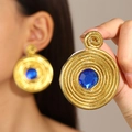 French vintage gold spiral earrings with blue gemstone centerpiece on model - Blue Rhinestone Spiral Style (G-557) / Gold