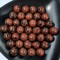 Polished red jasper stone spheres with black speckles arranged in a black bowl - 25mm No Hole Sphere / Mahogany Obsidian