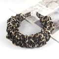 Detail view of leopard print knotted headband featuring pleated fabric texture and pattern - Premium Leopard