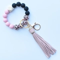 Detail of leopard print silicone beads and pink leather tassel on a gold keychain ring - Pink