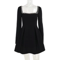 Close-up detail of white pearl embellishments on the square neckline of a black dress - S / Black