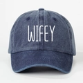 Detailed view of dark blue washed denim baseball cap with white WIFEY embroidery - Navy Blue