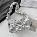 Close-up of pleated shoulder bag with black bow patterns and white ribbon details - Black Grid Black Bow
