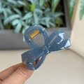 Macro detail of the grey-blue resin bow hair claw clip with a strong gold metal spring - Haze Blue - Small Bowknot